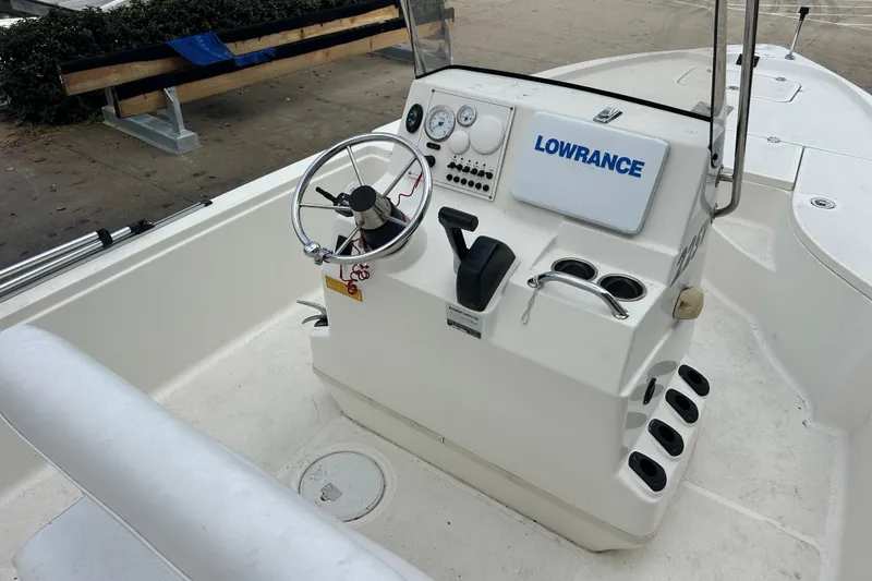 Slide: The Image of 2006 Triton 22 Bay Flight boat console with steering wheel and Lowrance equipment. - 14