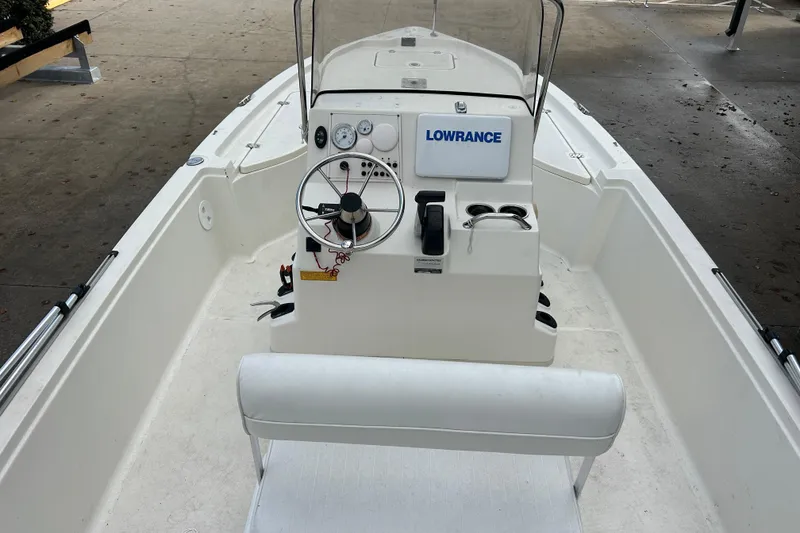 Slide: The Image of 2006 Triton 22 Bay Flight boat interior with steering console and Lowrance equipment. - 15