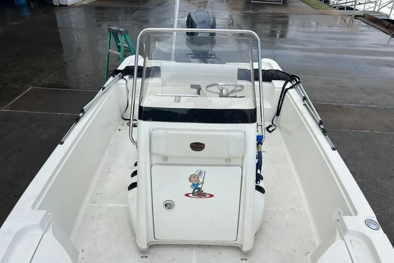 Slide: The Image of 2006 Triton 22 Bay Flight boat interior with steering console and seating. - 16