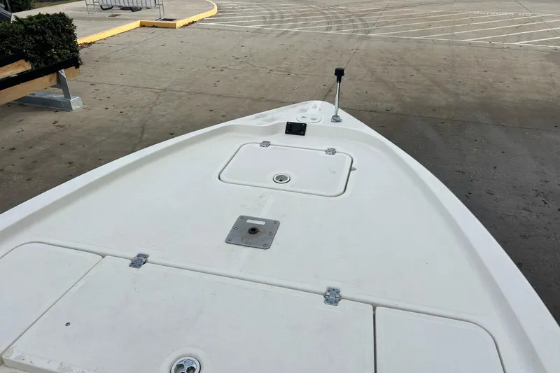 Slide: The Image of 2006 Triton 22 Bay Flight boat deck, featuring storage compartments and a clean, white surface. - 17