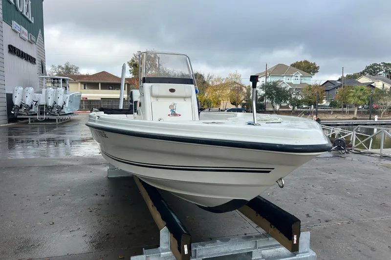 Slide: The Image of 2006 Triton 22 Bay Flight boat on trailer at marina, overcast sky. - 2