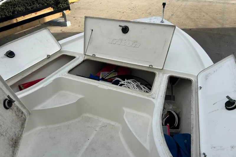 Slide: The Image of Open storage compartments on a 2006 Triton 22 Bay Flight boat, showing ropes and equipment. - 20