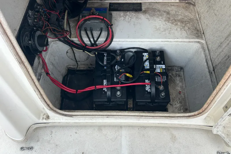 Slide: The Image of Battery compartment of a 2006 Triton 22 Bay Flight boat with wiring connections. - 21