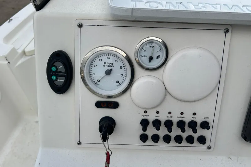Slide: The Image of Control panel of a 2006 Triton 22 Bay Flight boat with gauges and switches. - 23