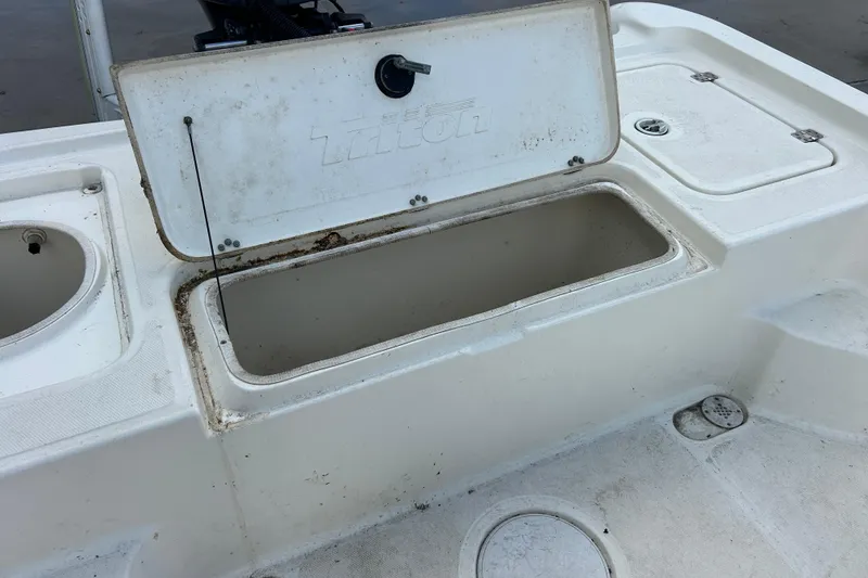 Slide: The Image of Open storage compartment on 2006 Triton 22 Bay Flight boat deck. - 28