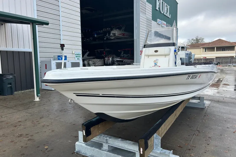 Slide: The Image of 2006 Triton 22 Bay Flight boat on trailer at marina storage facility. - 3