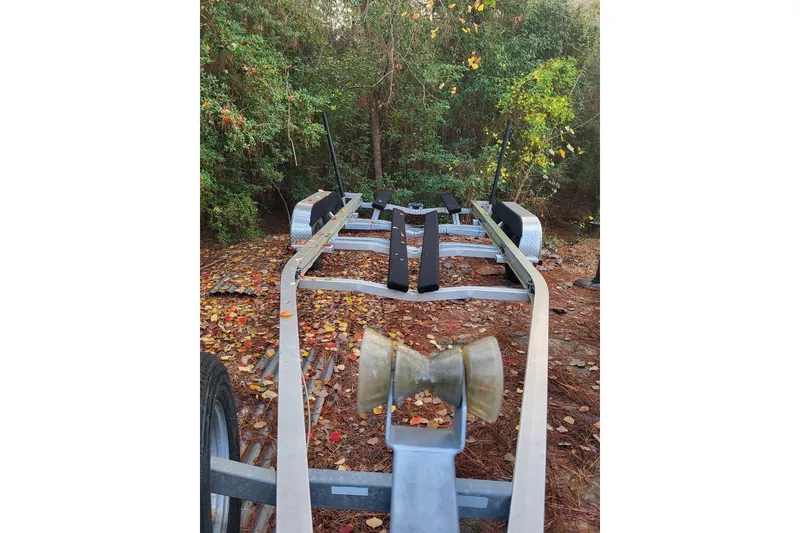 Slide: The Image of Trailer for 2006 Triton 22 Bay Flight boat in wooded area with fallen leaves. - 32
