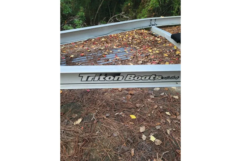 Slide: The Image of Trailer for 2006 Triton 22 Bay Flight boat, surrounded by autumn leaves. - 34