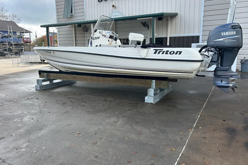 Slide: The Image of 2006 Triton 22 Bay Flight boat with Yamaha motor on display outside. - 8