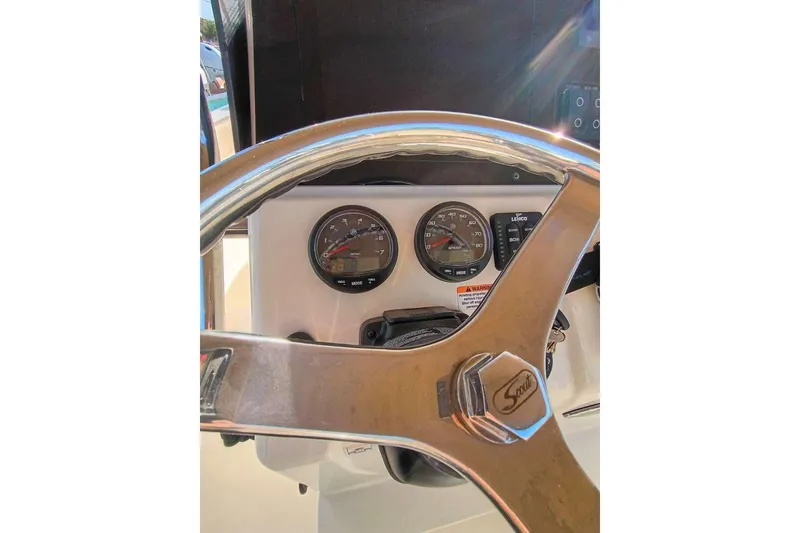 Slide: The Image of Steering wheel and dashboard of 2024 Scout 215 XSF boat with gauges. - 10