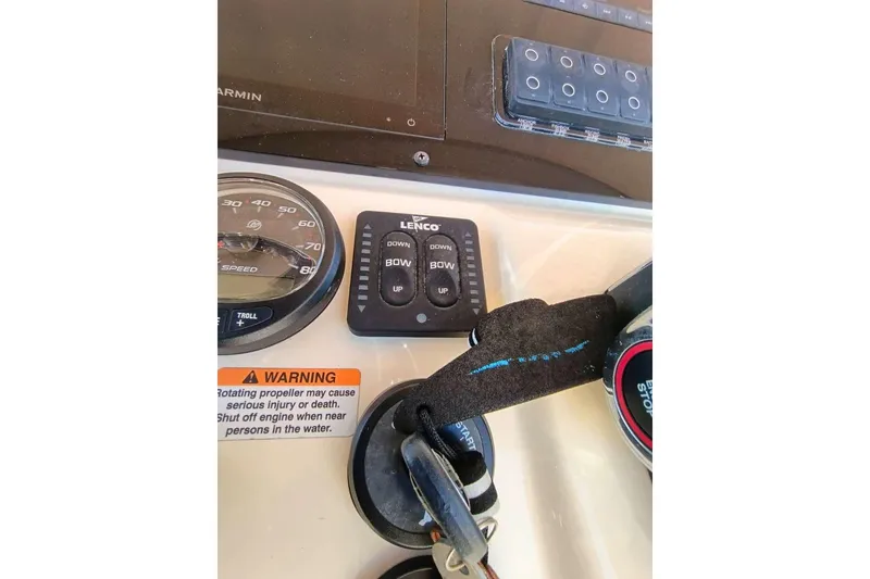 Slide: The Image of 2024 Scout 215 XSF dashboard with speedometer, Lenco controls, and safety warning label. - 11