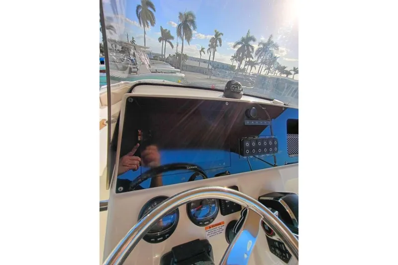 Slide: The Image of 2024 Scout 215 XSF boat dashboard with steering wheel and control panel. - 13