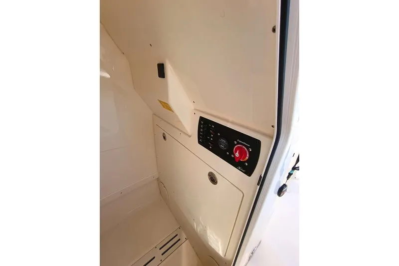 Slide: The Image of 2024 Scout 215 XSF boat interior with control panel and storage compartment. - 17