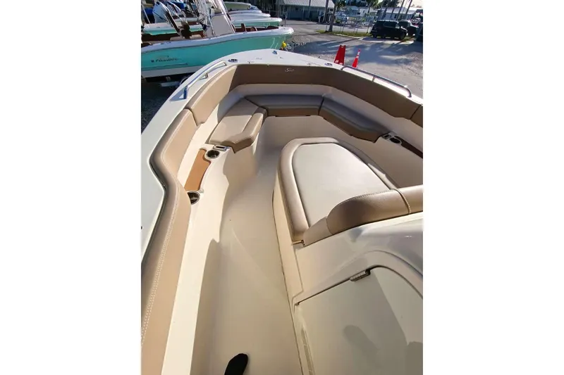 Slide: The Image of 2024 Scout 215 XSF boat interior with beige seating and cup holders. - 19
