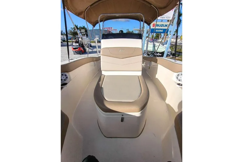 Slide: The Image of 2024 Scout 215 XSF boat interior with tan seating and canopy. - 24