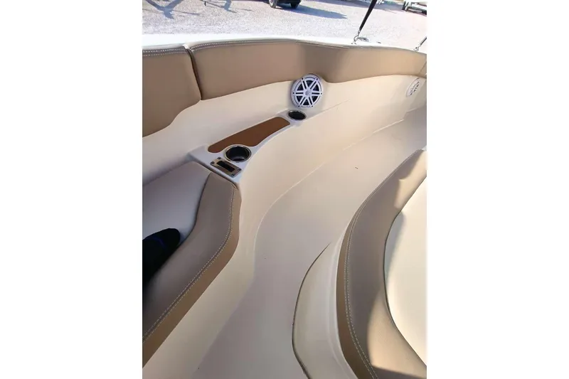 Slide: The Image of 2024 Scout 215 XSF boat interior with tan seating and built-in cup holders. - 25