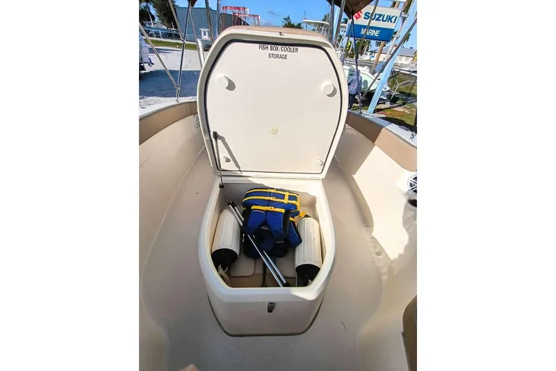 Slide: The Image of 2024 Scout 215 XSF boat with open fish box cooler storage, life jacket inside. - 26
