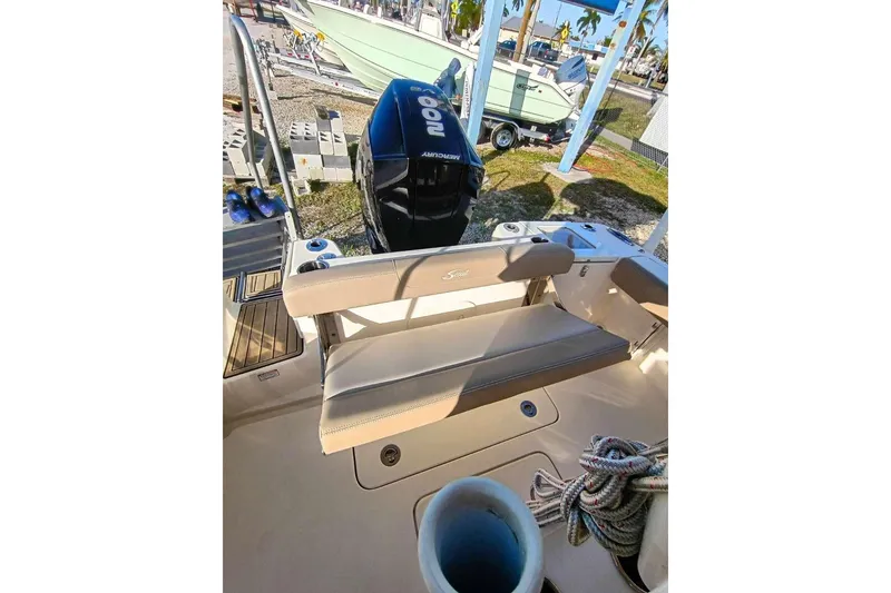Slide: The Image of 2024 Scout 215 XSF boat interior with seating and Mercury outboard motor. - 29