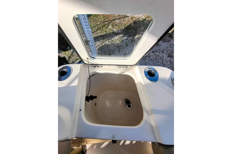 Slide: The Image of 2024 Scout 215 XSF boat interior with storage compartment and cup holders. - 30