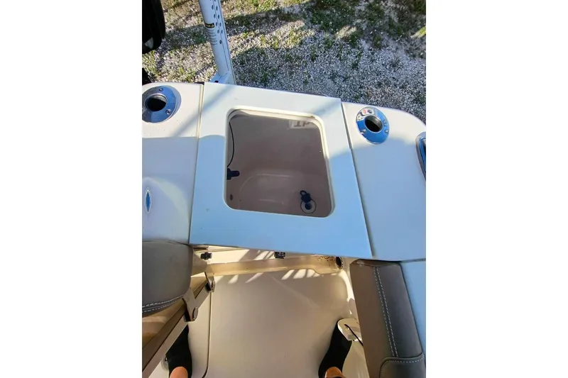 Slide: The Image of 2024 Scout 215 XSF boat interior with storage compartment and cup holders. - 31