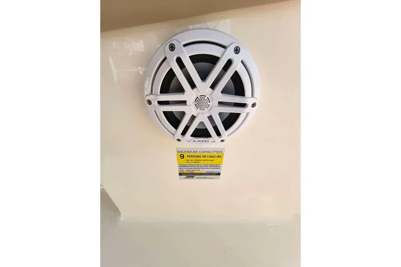 Slide: The Image of 2024 Scout 215 XSF boat speaker and capacity label for 9 people or 1500 lbs. - 32