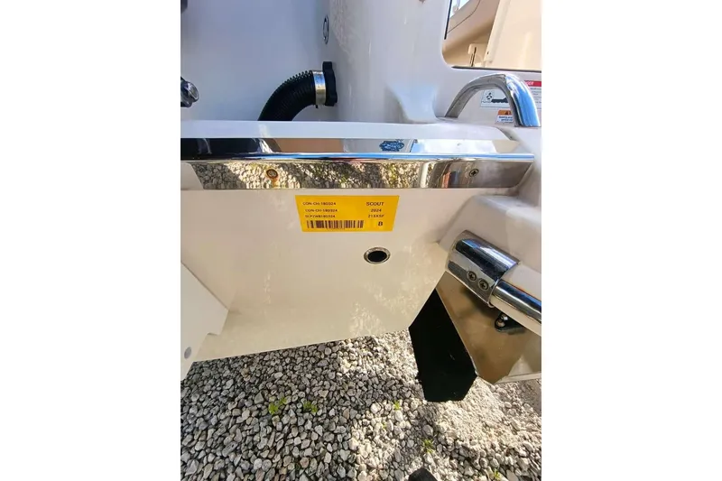 Slide: The Image of 2024 Scout 215 XSF boat detail with identification label and chrome fittings. - 33