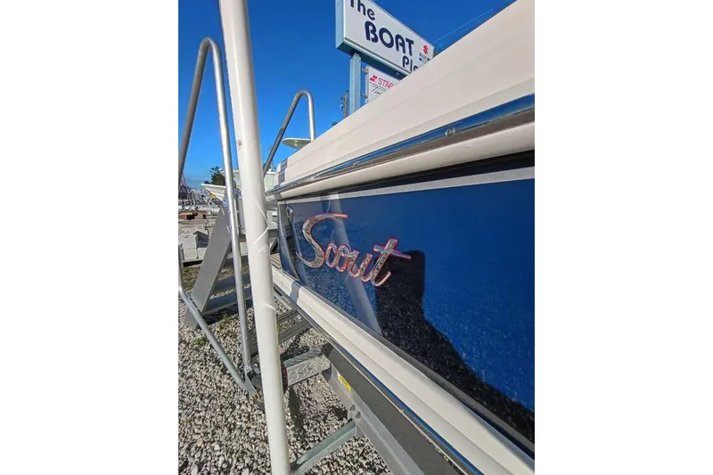 Slide: The Image of 2024 Scout 215 XSF boat side view with logo, displayed outdoors. - 36