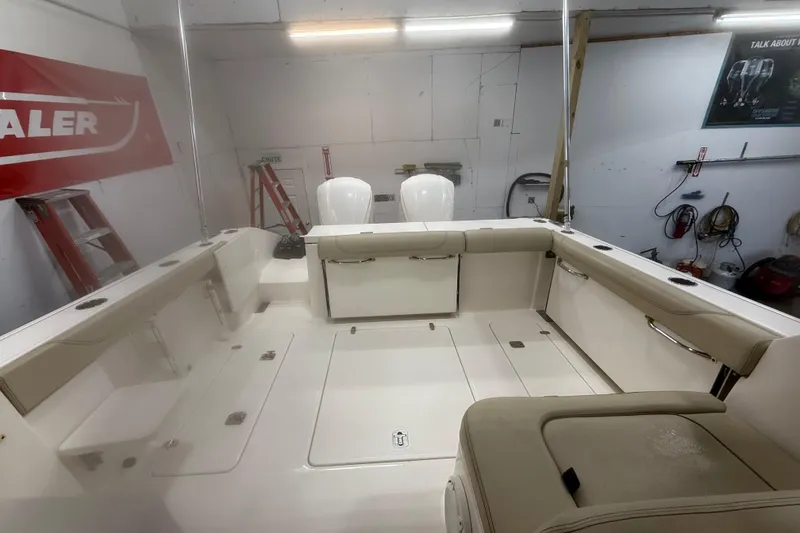 Slide: The Image of 2018 Pursuit DC 325 Dual Console boat interior in a workshop setting. - 8