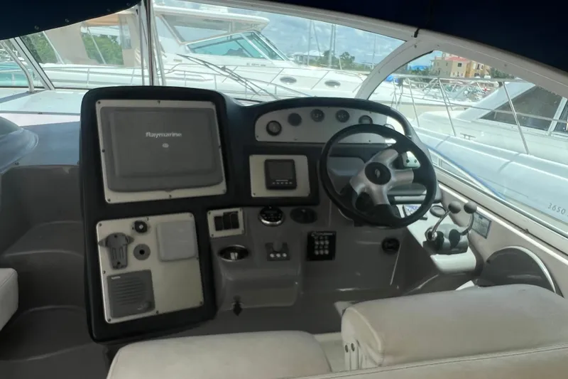 Slide: The Image of 2007 Cruisers Yachts 420 Express helm with steering wheel and navigation controls. - 3