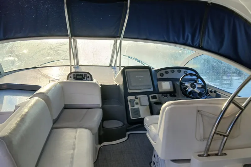 Slide: The Image of 2007 Cruisers Yachts 420 Express interior with helm and seating area. - 2