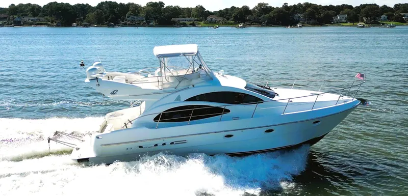 Slide: The Image of Azimut 42 yacht cruising on a sunny day, 2002 model, on a serene lake. - 10