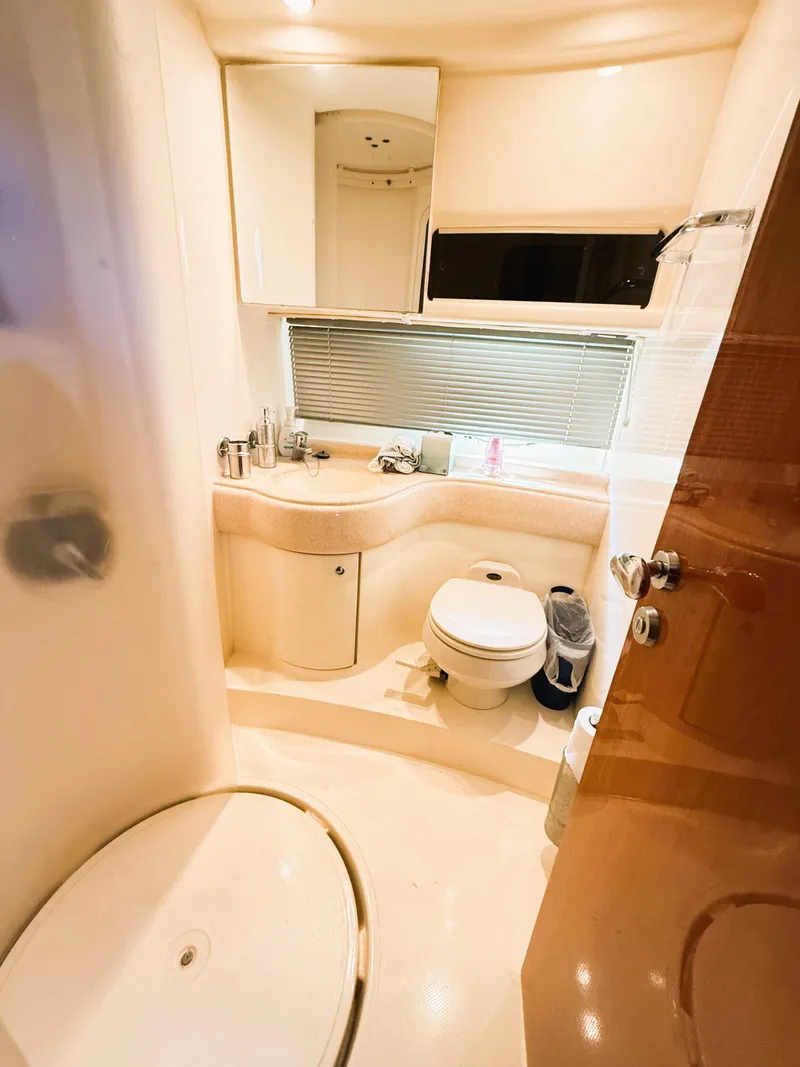 Slide: The Image of Luxurious bathroom interior of 2002 Azimut 42 yacht, featuring modern fixtures and elegant design. - 33
