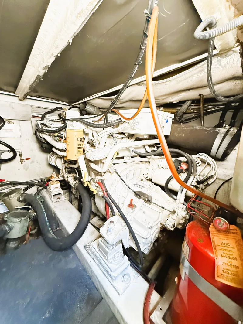 Slide: The Image of Engine room of a 2002 Azimut 42 yacht, featuring complex wiring and equipment. - 42