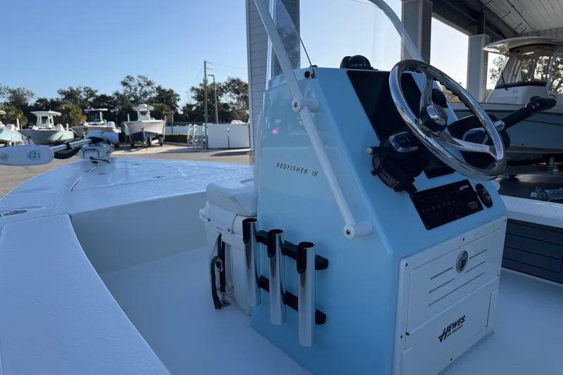 Slide: The Image of 2022 Hewes Redfisher 18 boat at dock, steering console in foreground. - 10