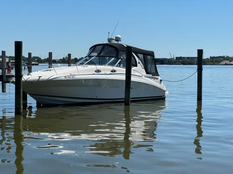 The Image of 2006 Sea Ray 320 Sundancer boat docked on calm water. - 0