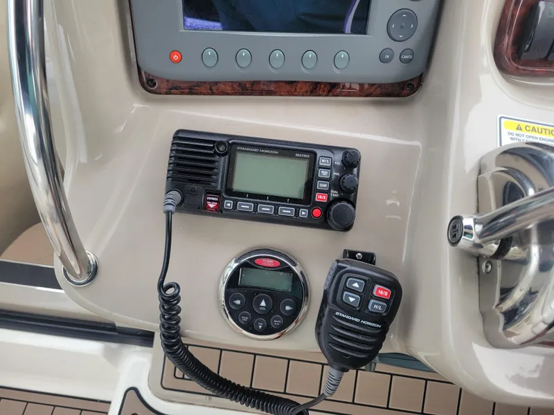 Slide: The Image of Control panel of a 2006 Sea Ray 320 Sundancer boat with radio and navigation equipment. - 12