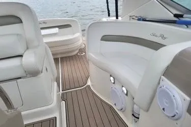 Slide: The Image of 2006 Sea Ray 320 Sundancer boat interior with cushioned seating and wood-style flooring. - 15