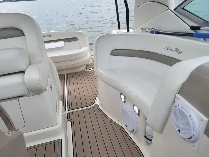Slide: The Image of Interior of 2006 Sea Ray 320 Sundancer boat with white leather seating and wood flooring. - 17