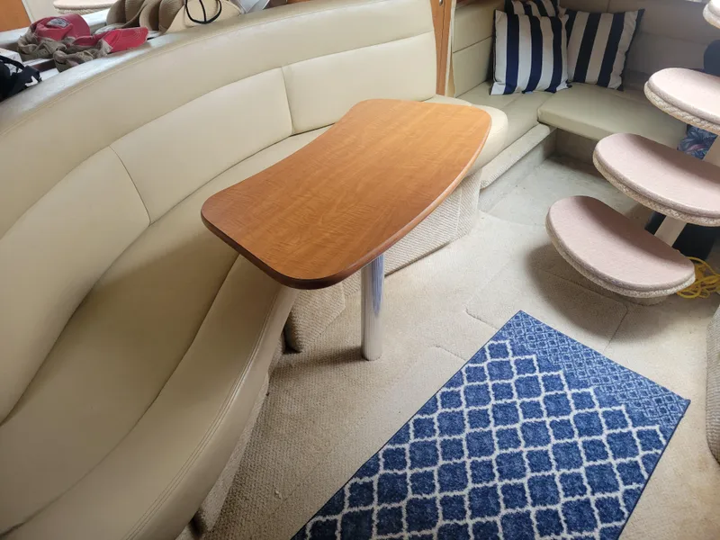 Slide: The Image of Interior of 2006 Sea Ray 320 Sundancer with beige seating and wooden table. - 22