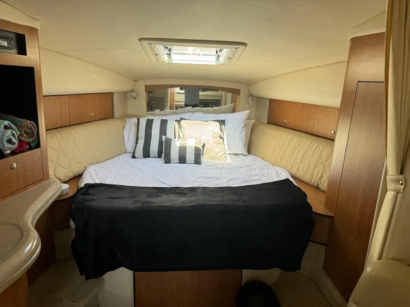 Slide: The Image of 2006 Sea Ray 320 Sundancer cabin interior with bed and skylight. - 27