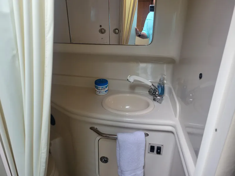 Slide: The Image of 2006 Sea Ray 320 Sundancer bathroom with sink, mirror, and storage. - 29