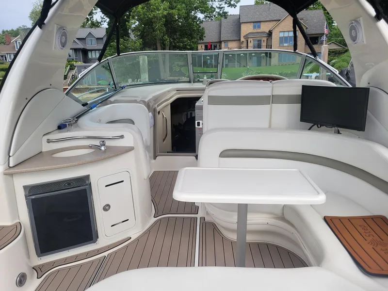 Slide: The Image of 2006 Sea Ray 320 Sundancer boat interior with seating, table, and kitchenette. - 6