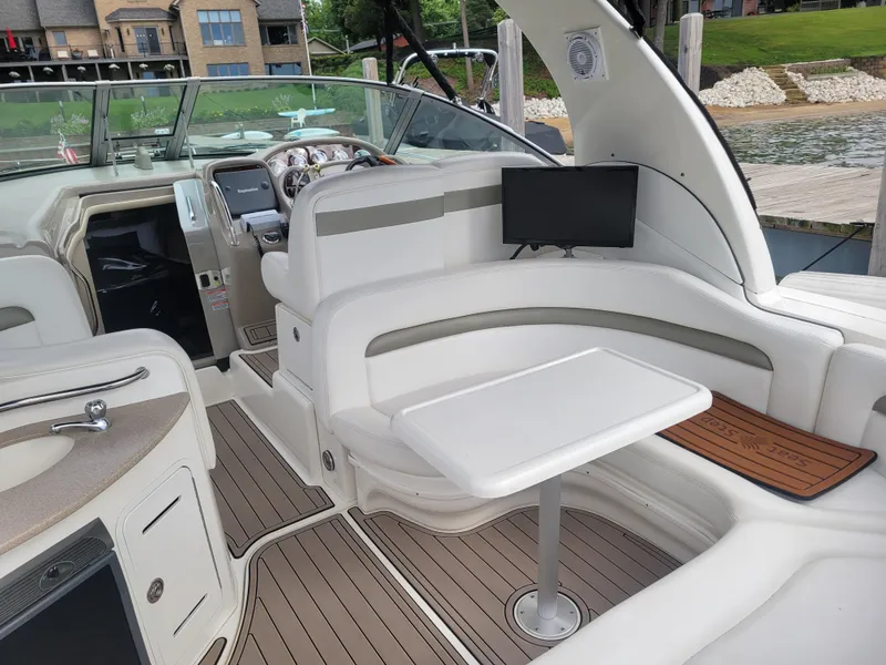 Slide: The Image of 2006 Sea Ray 320 Sundancer interior with seating, table, and helm station. - 7