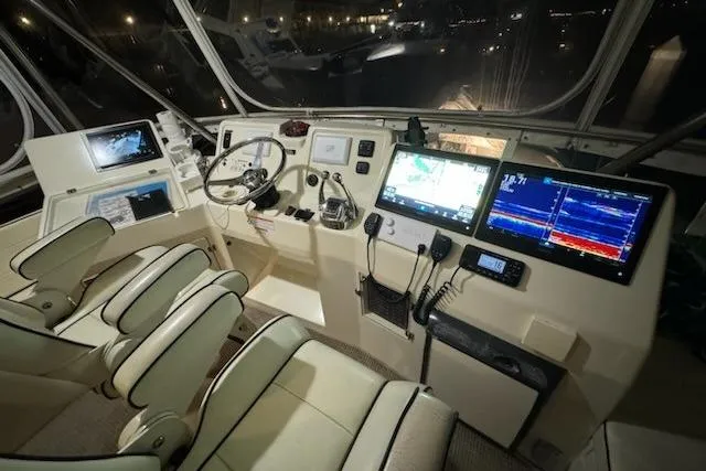 Slide: The Image of 2009 Mikelson Zeus Sportfisher cockpit with advanced navigation and control systems. - 23