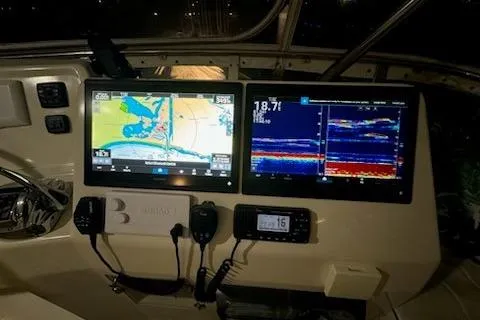 Slide: The Image of 2009 Mikelson Zeus Sportfisher dashboard with navigation and sonar displays. - 24