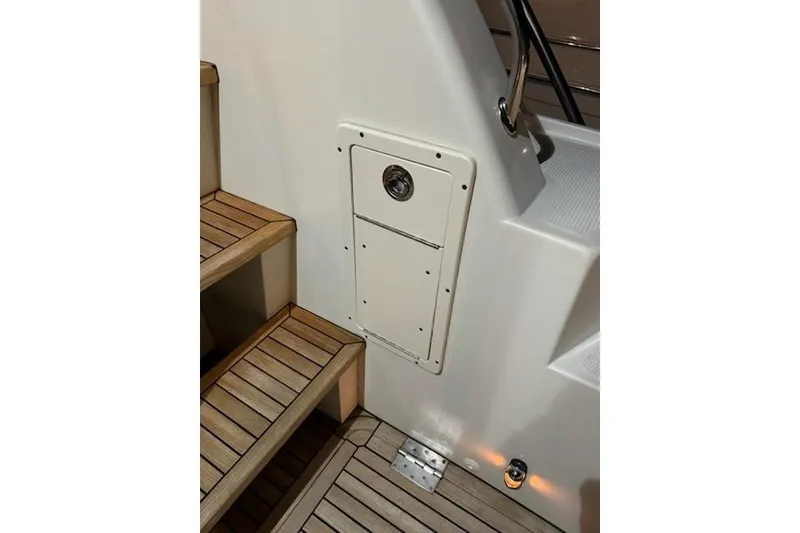 Slide: The Image of 2009 Mikelson Zeus Sportfisher boat stairs and hatch detail with wooden finish. - 34