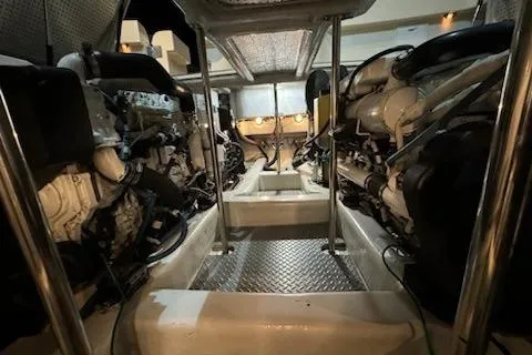 Slide: The Image of Engine room of 2009 Mikelson Zeus Sportfisher, showcasing dual engines and metallic flooring. - 41