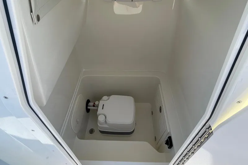 Slide: The Image of 2026 Pathfinder 2400 Open boat interior with compact marine toilet. - 12
