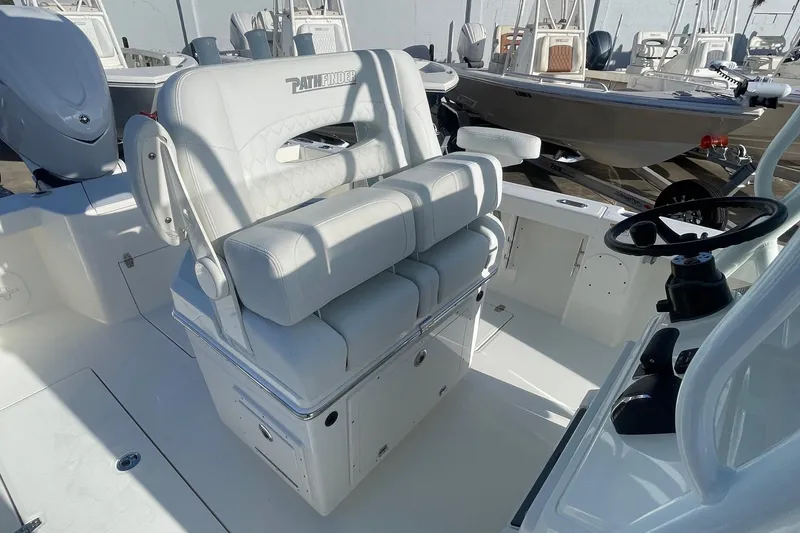 Slide: The Image of 2026 Pathfinder 2400 Open boat interior with white seating and steering wheel. - 7