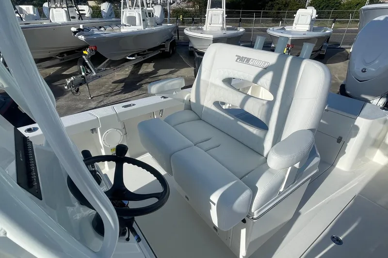 Slide: The Image of 2026 Pathfinder 2400 Open boat interior with white seating and steering wheel. - 8